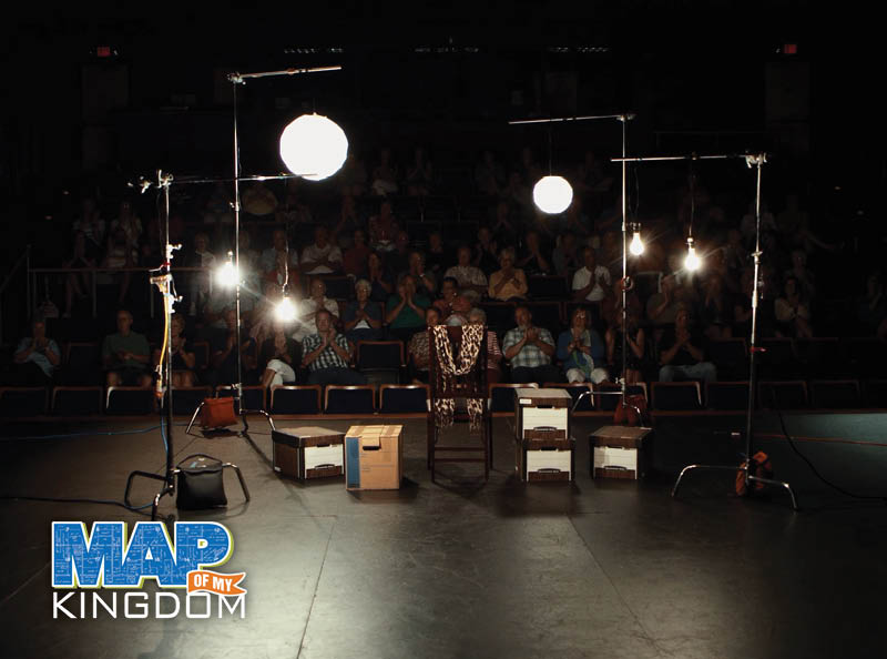 Audience watching Map of My Kingdom play crowd logo by Mary Swander